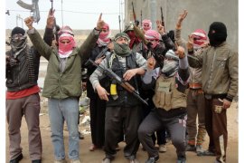 Iraqi men from local tribes brandish their weapons as they pose for a photograph in the city of Fallujah, west of the capital Baghdad, on January 5, 2014. Iraq is preparing a "major attack" to retake militant-held Fallujah, a senior official said, spelling a new assault for the city, west of Baghdad, where US forces repeatedly battled insurgents. AFP PHOTO/SADAM El-MEHMEDYEDY