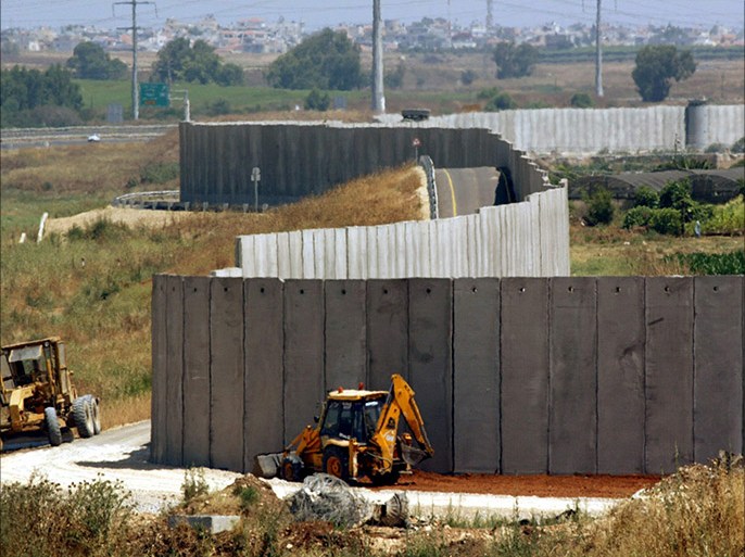 View of the tall Israeli-built concrete separation wall along what is referred to as the "seam line" that is under construction at Qalqilya in the West Bank (out of view to the right)