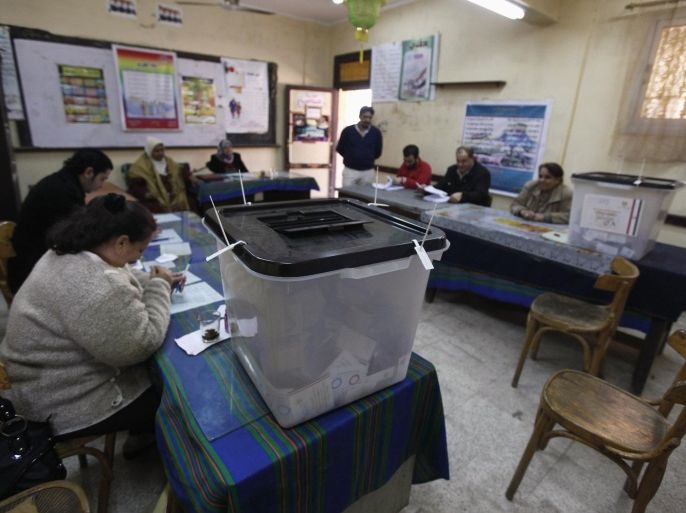 Election workers and ballot boxes are seen inside a polling station during a referendum on the new constitution in Cairo, January 15, 2014. Egyptians began voting on Tuesday in a constitutional referendum, the first ballot since the military overthrew Islamist president Mohamed Mursi and an event likely to spawn a presidential bid by army chief General Abdel Fattah al-Sisi. REUTERS/Mohamed Abd El Ghany (EGYPT - Tags: POLITICS ELECTIONS)