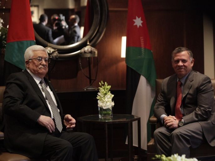 Palestinian President Mahmoud Abbas, left, meets with King Abdullah II of Jordan, at the royal palace in Amman, Wednesday, Jan. 8, 2014. (AP Photo/Mohammad Hannon)