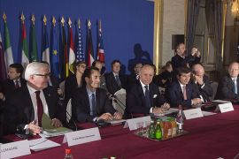 France's Foreign Minister Laurent Fabius (3rdL) presides at the Quai d'Orsay, the French Foreign ministry in Paris on January 12, 2014, the conference of "Friends of Syria". The group meets with leaders of the mainstream opposition to