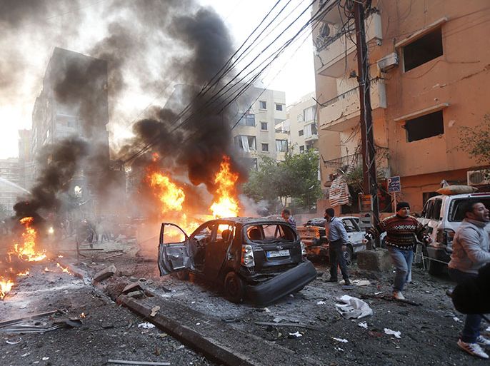 Flames rise from burning cars at the site of a car bomb that targeted Beirut's southern suburb of Haret Hreik on January 2, 2014. A large car bomb killed five people and wounded at least 20 in south Beirut, a health ministry source told AFP. AFP