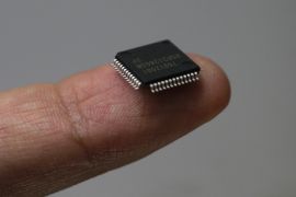 A Renesas Electronics Corp's microcontroller chip sits on a finger in this file illustrative photograph taken in Tokyo May 24, 2012. Once-dominant Japanese firms have been battered by rising costs and the investment clout of Samsung and Chang's Taiwan Semiconductor Manufacturing (TSMC). The Japanese have the technology, but the likes of Elpida Memory, a maker of DRAM memory chips for computers, and Renesas Electronics Corp, the world's leading maker of microcontroller chips for automobiles, just don't have the money to plough into the constant plant and technology upgrades. The world's top foundries are Taiwanese: TSMC and United Microelectronics (UMC). TSMC had revenue last year of $14.5 billion and a 49 percent market share, about four times the size of UMC, according to industry researcher Gartner. Then come GlobalFoundries, the former manufacturing arm of Advanced Micro Devices (AMD), which is backed by the Abu Dhabi sovereign fund and had revenue last year of $3.58 billion, China's SMIC and Israel's Towerjazz. REUTERS/Kim Kyung-Hoon/Files (JAPAN - Tags: BUSINESS SCIENCE TECHNOLOGY)
