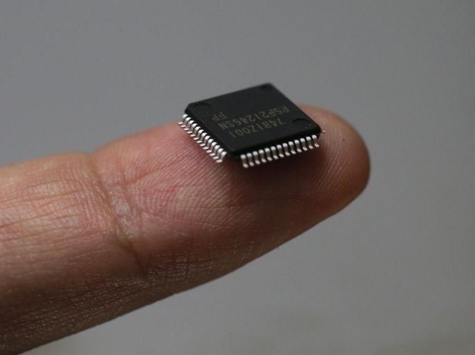 A Renesas Electronics Corp's microcontroller chip sits on a finger in this file illustrative photograph taken in Tokyo May 24, 2012. Once-dominant Japanese firms have been battered by rising costs and the investment clout of Samsung and Chang's Taiwan Semiconductor Manufacturing (TSMC). The Japanese have the technology, but the likes of Elpida Memory, a maker of DRAM memory chips for computers, and Renesas Electronics Corp, the world's leading maker of microcontroller chips for automobiles, just don't have the money to plough into the constant plant and technology upgrades. The world's top foundries are Taiwanese: TSMC and United Microelectronics (UMC). TSMC had revenue last year of $14.5 billion and a 49 percent market share, about four times the size of UMC, according to industry researcher Gartner. Then come GlobalFoundries, the former manufacturing arm of Advanced Micro Devices (AMD), which is backed by the Abu Dhabi sovereign fund and had revenue last year of $3.58 billion, China's SMIC and Israel's Towerjazz. REUTERS/Kim Kyung-Hoon/Files (JAPAN - Tags: BUSINESS SCIENCE TECHNOLOGY)