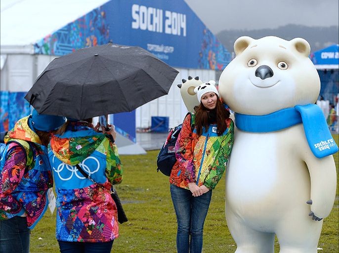 Volunteers pose by the Sochi Olympics polar bear mascot prior to the start of the Sochi 2014 Winter Olympics at the Olympic Village on January 31, 2014 in Sochi