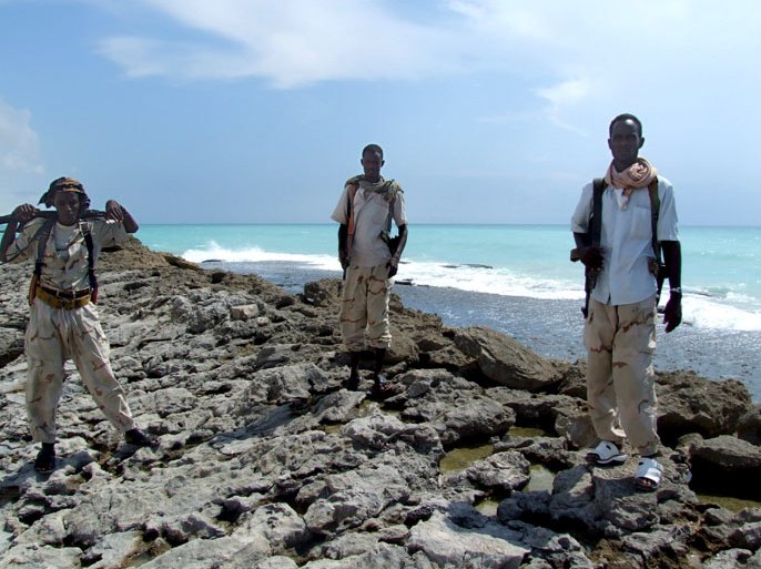 epa01527471 In the 16 October 2008 photo made available on 22 October 2008 armed Somali pirates guard the beach in Hobyo district 540kms north east of Mogadishu. Somali pirates dominate the towns Haradhere, Hobyo and El-Hur which has forced most of the local population to flee in fear of concentrated military action from the richest nations on the world against the pirates. An increase in piracy off the Indian Ocean coast of Somalia has made these waters the most dangerous for pirate activities in the world, with 93 attacks in 2008, shipping companies say. EPA/BADRI MEDIA