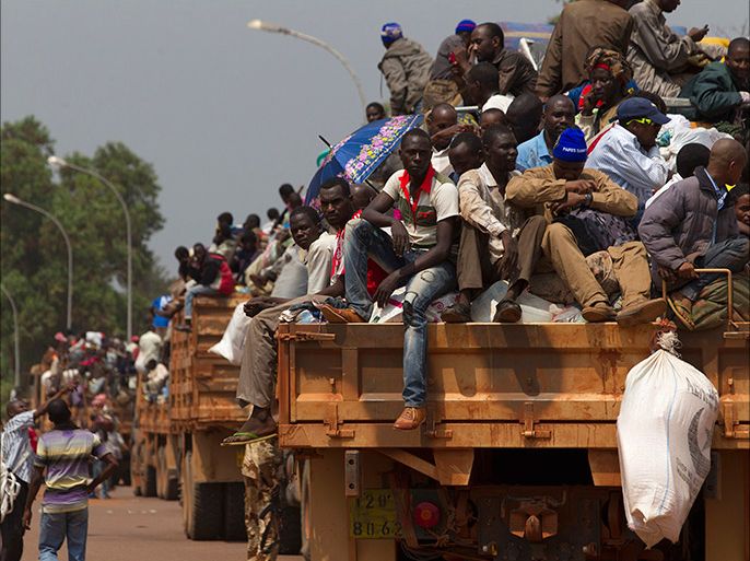 A convoy of trucks carrying people and their belongings stands by during a road repatriation to Chad in the capital Bangui January 22, 2014. Central African Republic's new interim president said on Tuesday she would hold talks with armed groups in an effort to restore order to the former French colony, where at least seven more people were killed in sectarian violence in the north. REUTERS/Siegfried Modola (CENTRAL AFRICAN REPUBLIC - Tags: POLITICS SOCIETY IMMIGRATION CONFLICT CIVIL UNREST)