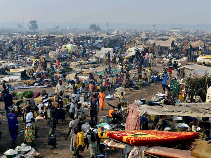 People gather at camp for internally displaced persons (IDP) set up amid old aircrafts near the airport in Bangui on December 29, 2013. Desperate Chadian refugees who fled chaos in the Central African Republic on Sunday recounted the horror they went through when they were attacked and threatened by angry mobs as the country became engulfed in sectarian violence. AFP PHOTO / MIGUEL MEDINA