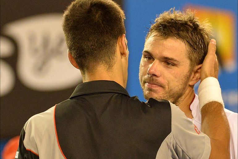 Switzerland's Stanislas Wawrinka (R) hugs Serbia's Novak Djokovic after winning their men's singles match on day nine at the 2014 Australian Open tennis tournament in Melbourne on January 21, 2014. IMAGE RESTRICTED TO EDITORIAL USE - STRICTLY NO COMMERCIAL USE AFP PHOTO / PAUL CROCK