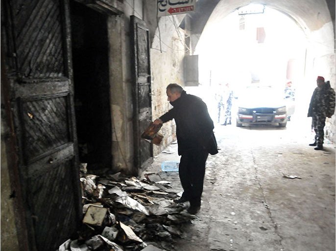 A man inspects burnt books on January 4, 2014 in north Lebanon's majority Sunni city of Tripoli a day after a decades-old library owned by a Greek Orthodox priest was torched after "a pamphlet was discovered inside one of the books that was insulting to Islam and the prophet Mohammad" said a source, who spoke to AFP on condition of anony