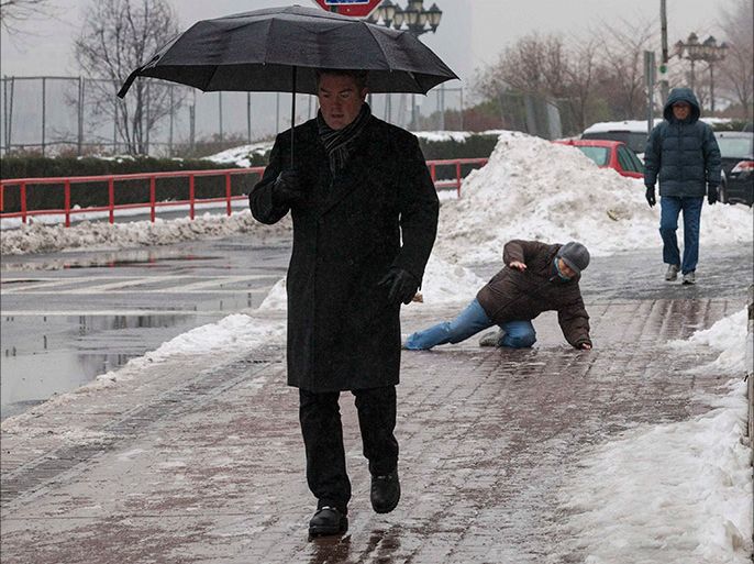 A man falls while slipping on ice during freezing rain on Roosevelt Island, a borough of Manhattan in New York January 5, 2014. New York City was hit on Friday by the first severe winter storm of 2014