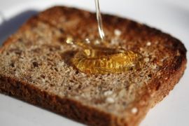 (20/20) Raw honey is poured onto toast for eating in Cape Town, South Africa, 19 May 2012. Honey and wax from hives are used for food, cosmetics and medicines. Today bees are threatened by a combination of various factors, deforestation, mites, Colony Collapse Disorder and industrial agriculture. EPA/NIC BOTHMA PLEASE SEE ADVISORY NOTICE (epa03254042) FOR FULL FEATURE TEXT