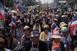 Thai anti government protesters wave national flags during a rally in Bangkok on January 7, 2014. Demonstrators, who are seeking to curb the political dominance of Prime Minister Yingluck Shinawatra's billionaire family, say they will "shut down"