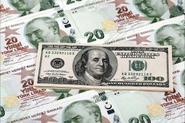 A file photo illustration taken on January 7, 2014 in Istanbul shows a 100 U.S. dollar banknote against 20 Turkish lira banknotes. Turkey's lira touched a new record low against the dollar on January 23, 2014, after the central bank left i