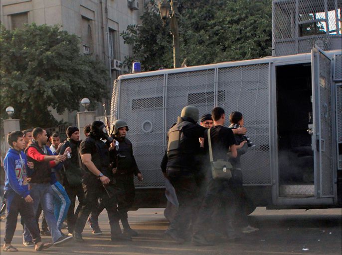 Riot police arrest anti-government protesters and members of the Muslim Brotherhood during clashes at Ramsis street, which leads to Tahrir Square in downtown Cairo, on the third anniversary of Egypt's uprising, January 25, 2014. Seven people were killed during anti-government marches on Saturday while thousands rallied in support of the army-led authorities, underlining Egypt's volatile political fissures three years after the fall of autocrat president Hosni Mubarak. Security forces lobbed teargas and fired in the air to try to prevent demonstrators opposed to the government from reaching Tahrir Square, the symbolic heart of the 2011 uprising that toppled the former air force commander. REUTERS/Amr Abdallah Dalsh (EGYPT - Tags: POLITICS CIVIL UNREST ANNIVERSARY)