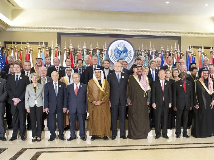 U.N. Secretary General Ban Ki-moon (front, 11th L), U.S. Secretary of State John Kerry (behind Ban) and Kuwaiti Foreign Minister Sheikh Sabah Khalid Al-Hamad Al-Sabah (front, 10th L) pose with other leaders for a group photo during the opening session of the Syrian Donors Conference at the Bayan Palace in Kuwait City January 15, 2014. Donors including the United States and wealthy Gulf Arab countries pledged $1 billion on Wednesday for U.N. humanitarian efforts in Syria, devastated by almost three years of civil war. REUTERS/Stephanie McGehee (KUWAIT - Tags: POLITICS)