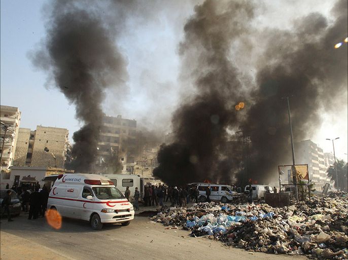 Smoke rises from a bus station hit by what activists said was an airstike by forces loyal to Syria's President Bashar al-Assad, as garbage fills the street in Jisr al-Hajj in Aleppo January 21, 2014. REUTERS/Ammar Abdullah (SYRIA - Tags: POLITICS CIVIL UNREST CONFLICT)