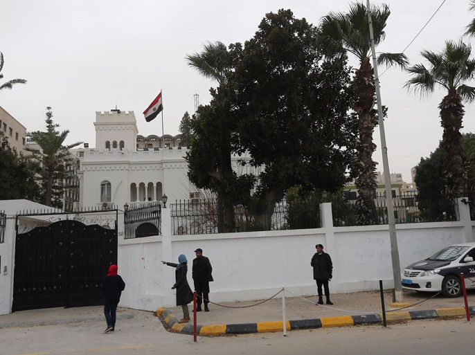 Women talk with policemen on January 25, 2014 in front of the Egyptian embassy, where Egypt's cultural attache and three other embassy staff were seized by kidnappers in Tripoli, Libya. The early morning abduction came a day after the seizure of an embassy administrative adviser from his home in the capital and despite Libya's announcement of "reinforced security measures" around the Egyptian embassy. AFP PHOTO MAHMUD TURKIA