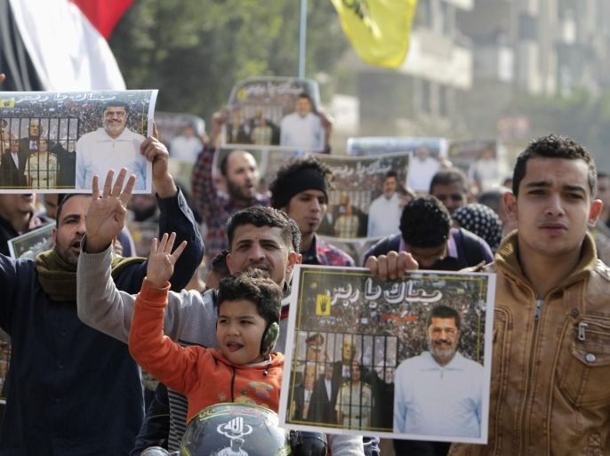 Supporters of the Muslim Brotherhood and ousted Egyptian President Mohamed Mursi protest against the military and interior ministry, while making the four-finger Rabaa gesture, at Nasr City district in Cairo January 3, 2014. The "Rabaa" or "four" gesture is in reference to the police clearing of the Rabaa al-Adawiya protest camp on August 14, 2013. REUTERS/ Mohamed Abd El Ghany (EGYPT - Tags: POLITICS CIVIL UNREST)
