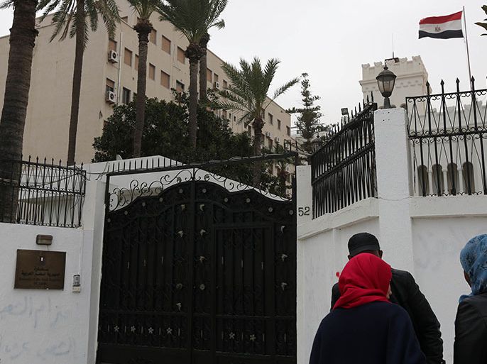 Women talk with policemen on January 25, 2014 in front of the Egyptian embassy, where Egypt's cultural attache and three other embassy staff were seized by kidnappers in Tripoli, Libya. The early morning abduction came a day after the seizure of an embassy administrative adviser from his home in the capital and despite Libya's announcement of "reinforced security measures" around the Egyptian embassy. AFP