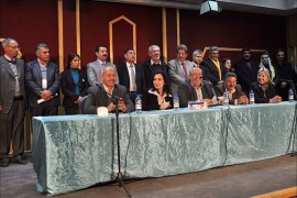 Members of the interim government of democratic self-administered party stand after declaring a provincial government, in the city of Amuda near Hasaka January 21, 2014. Kurds in Syria declared a provincial government in the north of the country on Tuesday, consolidating their geographic and political presence on the eve of peace talks in Switzerland at which they will not be represented. The municipal council will run affairs in one of three administrative districts set up by Kurds, who have seized upon the chaos of Syria's civil war to assert control in the northeast of the country. Picture taken January 21, 2014. REUTERS/Rodi Said (SYRIA - Tags: POLITICS CIVIL UNREST CONFLICT)