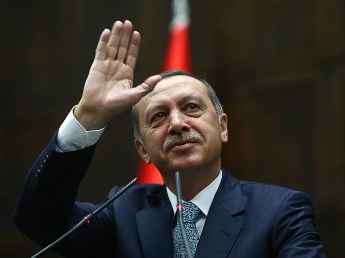 Ankara, Ankara, TURKEY : Turkey's Prime Minister Recep Tayyip Erdogan waves to members of his ruling AK Party (AKP) during a session at the Turkish parliament in Ankara on February 25, 2014. Erdogan on February 25 condemned leaked recordings of him and his son allegedly discussing how to hide large sums of money as a "vile attack", as he grappled with the latest setback in a damaging corruption scandal. AFP PHOTO/ADEM ALTAN
