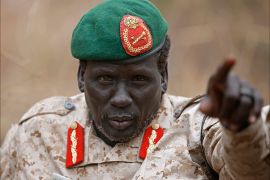 Rebel General Peter Gatdet Yaka gestures as he speaks to South Sudan's rebel leader Riek Machar (not seen) in a rebel controlled territory in Jonglei State February 1, 2014.