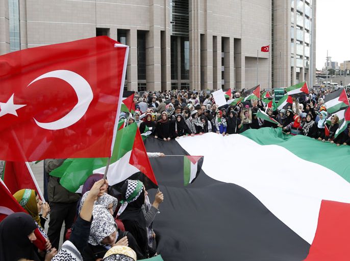 epa03459679 Turkish protestors shout slogans against Israel as they hold Palestinian and Turkish flags in front of the court during a demonstration for supporting the trial against Israel, in Istanbul, Turkey, 06 November 2012. Turkey on 06 November opened a trial in absentia of four former Israeli military commanders over the killing of nine Turks in the 2010 raid on a Gaza-bound aid ship, further deepening a dispute between the former allies. The four suspects on trial are former chief of staff Gaby Aschkenazi, former navy chief Eliezer Marom, former air force chief Amos Yadlin and the former head of air force intelligence Avishai Levi. EPA/TOLGA BOZOGLU