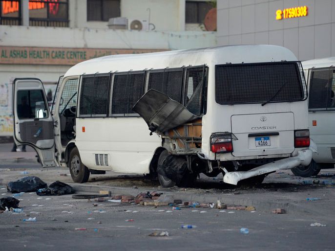 epa04078210 Riot police buses are damaged from a bomb believed to have been planted under them seen on the streets of Daih village, outskirts of the Bahraini capital Manama, 14 February 2014. Many parts of Bahrain were rocked by protests and clashes with police as the country marked the 3rd anniversary of the 14 February 2011 pro-reform protests. The clashes left several injuries among protesters and seven injuries among police as a result of two separate bombing incidents. Activists also reported 20 arrests estimating that 50 areas across the island had witnessed protests and clashes since the early morning hours. EPA/MAZEN MAHDI