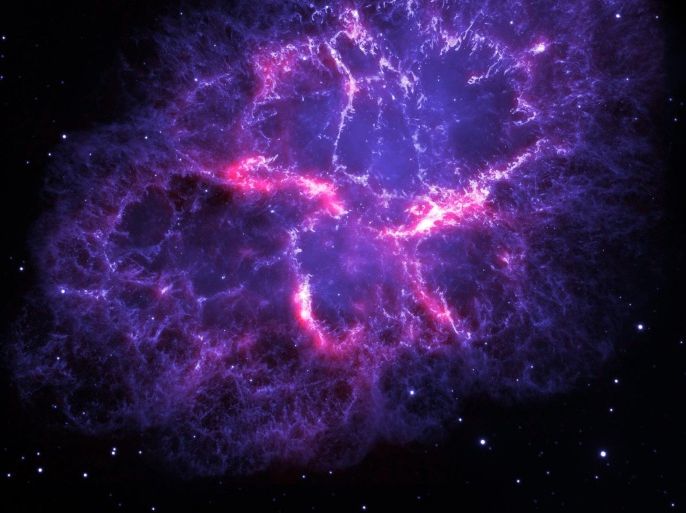 An undated handout photograph made available by ESA/Herschel/PACS/MESS Key Programme Supernova Remnant Team; NASA, ESA and Allison Loll/Jeff Hester (Arizona State University) on 14 December 2013 showing a composite view of the Crab nebula, an iconic supernova remnant in our Milky Way galaxy, as viewed by the Herschel Space Observatory and the Hubble Space Telescope. Herschel is a European Space Agency (ESA) mission with important NASA contributions, and Hubble is a NASA mission with important ESA contributions. A wispy and filamentary cloud of gas and dust, the Crab nebula is the remnant of a supernova explosion that was observed by Chinese astronomers in the year 1054. The image combines Hubble's view of the nebula at visible wavelengths, obtained using three different filters sensitive to the emission from oxygen and sulphur ions and is shown here in blue. Herschel's far-infrared image reveals the emission from dust in the nebula and is shown here in red. While studying the dust content of the Crab nebula with Herschel, a team of astronomers have detected emission lines from argon hydride, a molecular ion containing the noble gas argon. This is the first detection of a noble-gas based compound in space. The Herschel image is based on data taken with the Photoconductor Array Camera and Spectrometer (PACS) instrument at a wavelength of 70 microns; the Hubble image is based on archival data from the Wide Field and Planetary Camera 2 (WFPC2).