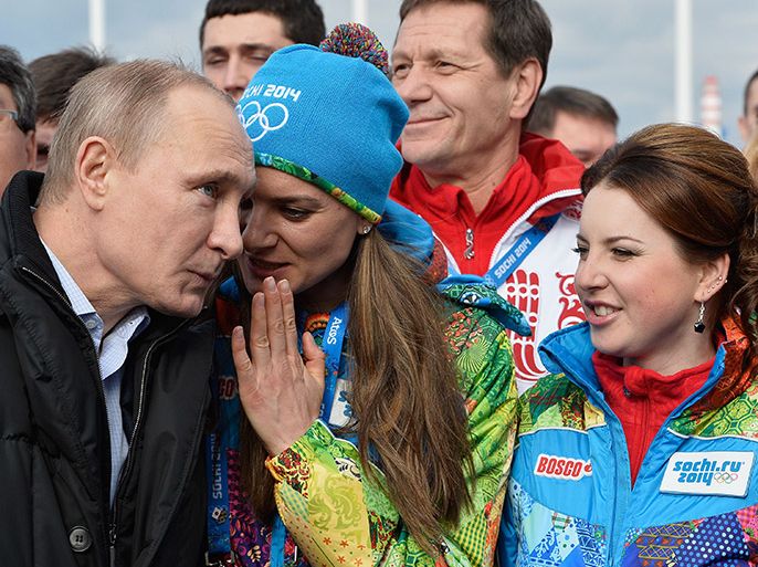 Russian President Vladimir Putin (L) listens to Russian pole vault champion and Olympic village mayor Elena Isinbayeva (C) during a visit at the Olympic village in Sochi on February 5, 2014, two days ahead of the opening ceremony for the Winter Olympics. AFP