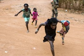 Children take cover as gunshots erupt during an operation in the Boy-rabe neighborhood of Bangui, Central African Republic, on February 15, 2014