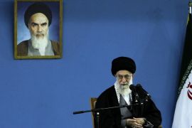 In this picture released by an official website of the office of the Iranian supreme leader, Supreme Leader Ayatollah Ali Khamenei delivers a speech under a picture of the late revolutionary founder Ayatollah Khomeini, in Tehran, Iran, Monday, Feb. 17, 2014. Iran's top leader backs the continuation of nuclear negotiations with the West but says he doubts they will succeed. (AP Photo/Office of the Iranian Supreme Leader)