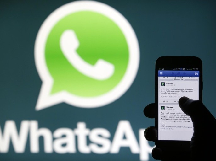 A Whatsapp App logo is seen behind a Samsung Galaxy S4 phone that is logged on to Facebook in the central Bosnian town of Zenica, February 20, 2014. Facebook Inc will buy fast-growing mobile-messaging startup WhatsApp for $19 billion in cash and stock in a landmark deal that places the world's largest social network closer to the heart of mobile communications and may bring younger users into the fold. REUTERS/Dado Ruvic (BOSNIA AND HERZEGOVINA - Tags: BUSINESS)