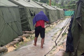 An undated photo obtained from the Refugee Action Coalition on February 18, 2014 shows a man walking between tents at Australia's regional processing centre on Manus Island in Papua New Guinea. One person was killed and 77 injured during a second night of rioting at an Australian immigration detention centre on Papua New Guinea's Manus Island, officials said on February 18.