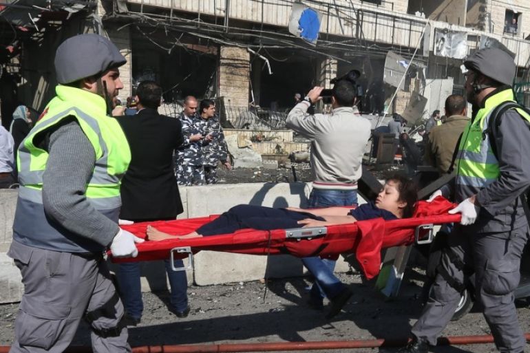 Lebanese civil defense workers carry an injured girl at the site of an explosion, near the Kuwaiti Embassy and Iran's cultural center, in the suburb of Beir Hassan, Beirut, Lebanon, Wednesday, Feb. 19, 2014. The bombing in a Shiite district in southern Beirut killed several people on Wednesday, security officials said — the latest apparent attack linked to the civil war in neighboring Syria that has killed and wounded scores of people over the last few months. (AP Photo/Hussein Malla)