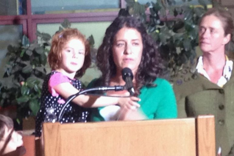 In this photo taken with a mobile phone, Jessica Tomei holds her 4-year-old daughter, Sofia Jarvis, during a news conference at Lucille Packard Children's Hospital at Stanford University on Monday, Feb. 24, 2014, in Palo Alto, Calif. Sofia is one of a handful of California children who has been diagnosed with a rare polio-like syndrome that has left her arm paralyzed. Stanford researchers say there is a possibility of an emerging infectious polio-like syndrome in California. (AP Photo/Martha Mendoza)