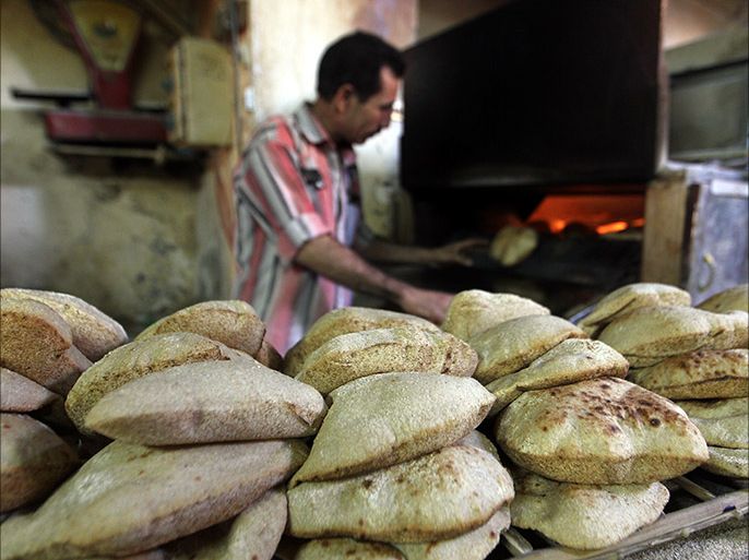 epa03632656 An Egyptian man prepares bread in a bakery iin Cairo, Egypt, 20 March 2013