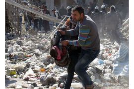 Syrian man carries the body of a victim out of the rubble of a destroyed building after an alleged air strike by Syrian government forces on the northern Syrian city of Aleppo on January 3, 2014. Al-Qaeda has disavowed the Islamic State of Iraq and the Levant (ISIL), whose members have been locked in deadly clashes with Syrian rebels, according to a statement posted on jihadist websites. AFP PHOTO/MOHAMMED AL-KHATIEB