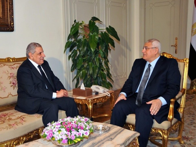 A handout photo made available by the Egyptian Presidency shows Egyptian interim President Adli Mansour (R) meeting with Egyptian Prime Minister-designate Ibrahim Mahlab (L), in Cairo, Egypt, 25 February 2014. Interim President Adli Mansour on 25 February appointed Mahlab as prime minister designate one day after outgoing premier Hazem Beblawy tendered his government's resignation. Mahlab said his priorities are restoring security and moving forward with the country's transitional roadmap. EPA/EGYPTIAN PRESIDENCY/HANDOUT