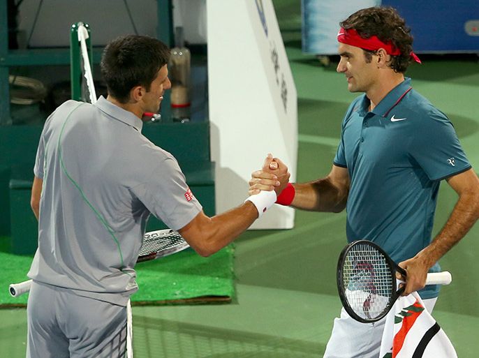 Novak Djokovic (L) of Serbia salutes Roger Federer of Switzerland at the end of their semi-final match in the ATP Dubai Duty Free Tennis Championships on February 28, 2014 in Dubai. Federer beat Djokovic 3-6, 6-3, 6-2 to play world number six Tomas Berdych in the finals. AFP