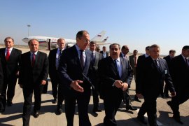 Russia's Foreign Minister Sergei Lavrov (C) walks with Iraq's Foreign Minister Hoshiyar Zebari (C-R) at Baghdad's airport in Baghdad, Iraq, 20 February