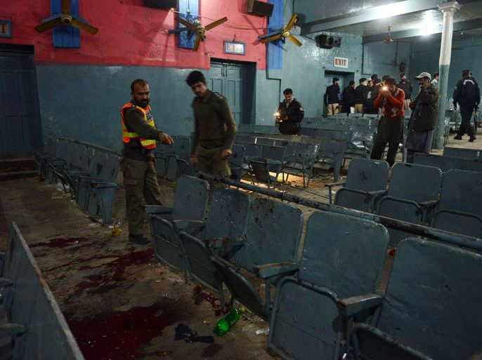 Pakistani investigators inspect the site of a grenade attack in a cinema in Peshawar on February 2, 2014. At least four people were killed and 31 wounded late on February 2 when unidentified attackers hurled two grenades at a cinema in northwest Pakistan, police and medics said. AFP