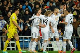 Real Madrid's French forward Karim Benzema (2ndR) is congratulated by teammates after scoring during the Spanish league football match Real Madrid CF vs Villarreal CF at the Santiago Bernabeu stadium in Madrid on February 8, 2014. AFP PHOTO/ PEDRO ARMESTRE