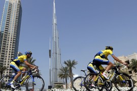 Cyclists ride past the Khalifa Tower during the four-stage event's 9.9 kilometre time trial as part of the Tour of Dubai on February 5, 2014 in the United Arab Emirate of Dubai. Taylor Phinney rode into cycling's history books, the American claiming the first stage on the inaugural Tour of Dubai. AFP