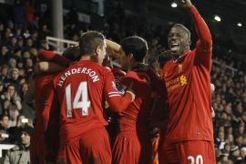 Liverpool's players celebrate Steven Gerrard's penalty goal against Fulham during their English Premier League soccer match at Craven Cottage, London, Wednesday, Feb. 12, 2014. (AP Photo/Sang Tan)