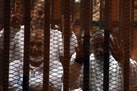 epa04045942 Leader of the Egypt's Muslim Brotherhood Mohammed Badie (R) and Egyptian member of the Muslim Brotherhood Safwat Hegazy (L) are pictured during the trial of Ousted Egyptian President Mohammed Morsi in a makeshift courtroom inside a police academy in Cairo, Egypt, 28 January 2014