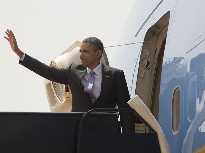 U.S. President Barack Obama waves during his departure on Air Force One at King Khalid International airport in Riyadh, Saudi Arabia, Saturday, March 29, 2014. (AP Photo/Pablo Martinez Monsivais)
