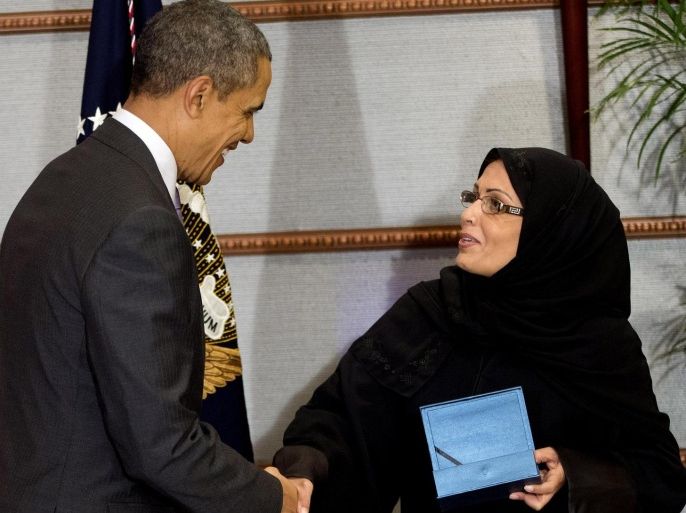 U.S. President Barack Obama presents Dr. Maha Al-Muneef with the U.S. Secretary of State's International Woman of Courage Award in Riyadh, Saudi Arabia, Saturday, March 29, 2014. Dr. Al-Muneef, founder and Executive Dir. of the National Family Safety Program (NFSP), was unable to attend the award ceremony in the U.S. this past March and was presented the award during Obama's visit to Saudi Arabia.(AP Photo/Pablo Martinez Monsivais)
