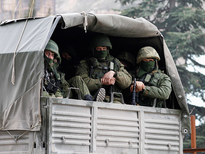 Armed servicemen wait in Russian army vehicles outside a Ukranian border guard post in the Crimean town of Balaclava March 1, 2014. Ukraine accused Russia on Saturday of sending thousands of extra troops to Crimea and placed its military in the area on high alert as the Black Sea peninsula appeared to slip beyond Kiev's control. REUTERS